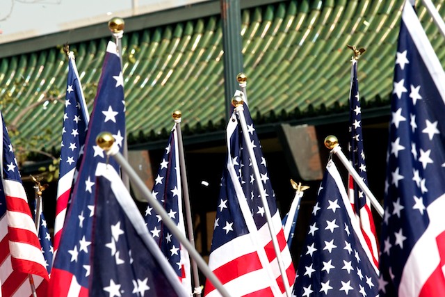 Members of a Rotary club carry American flags while marching in the 2011 Golden Dragon Chinese New Year Parade.