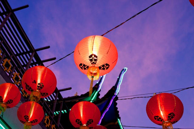 Lanterns glow at dusk in the main plaza of Chinatown.